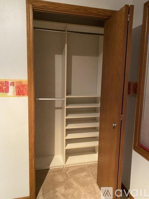 A wooden door with a glass panel and a handle.