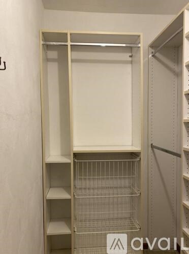 A white pantry with shelves and a door.