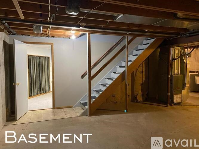 A basement with a staircase and a door.