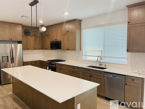 A kitchen with wooden cabinets and a white countertop.