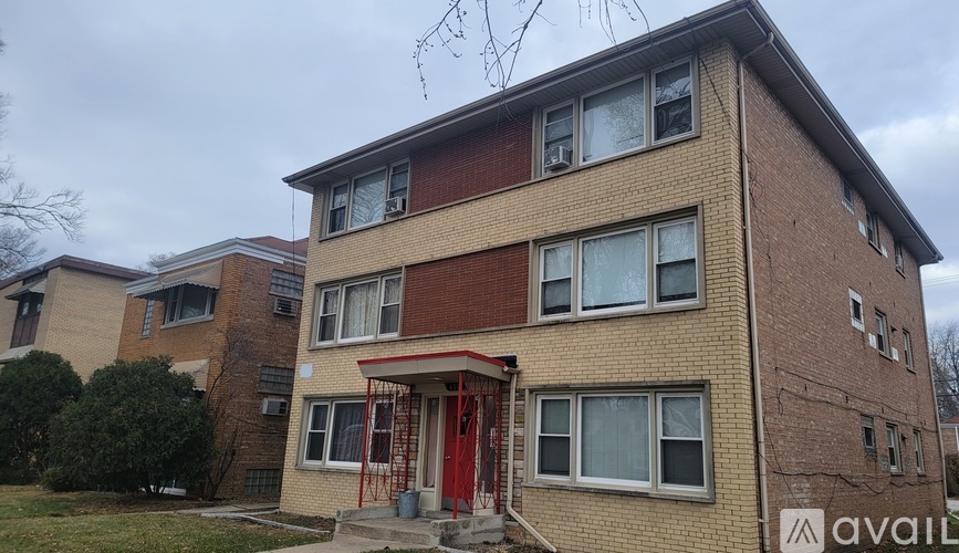 A building with a red door and a sign that says "available" in front of it.