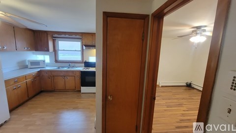 A kitchen with wooden cabinets and a white fridge.
