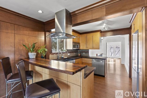 A modern kitchen with dark wood cabinets and a center island.