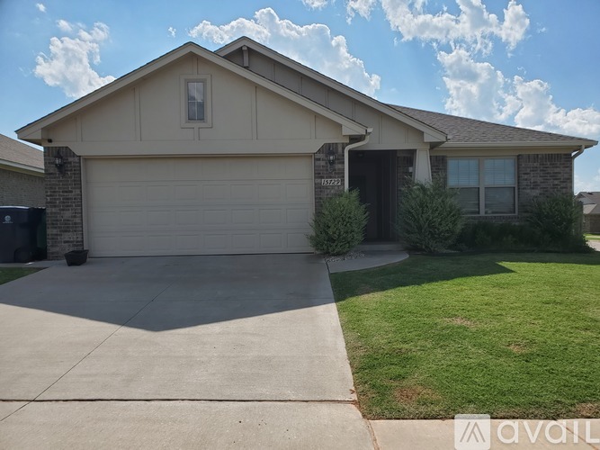 A house with a garage door and a driveway.