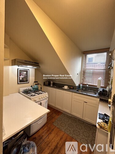 A kitchen with a stove top oven and a dishwasher.