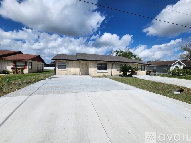 A house with a driveway in front of it is for sale.