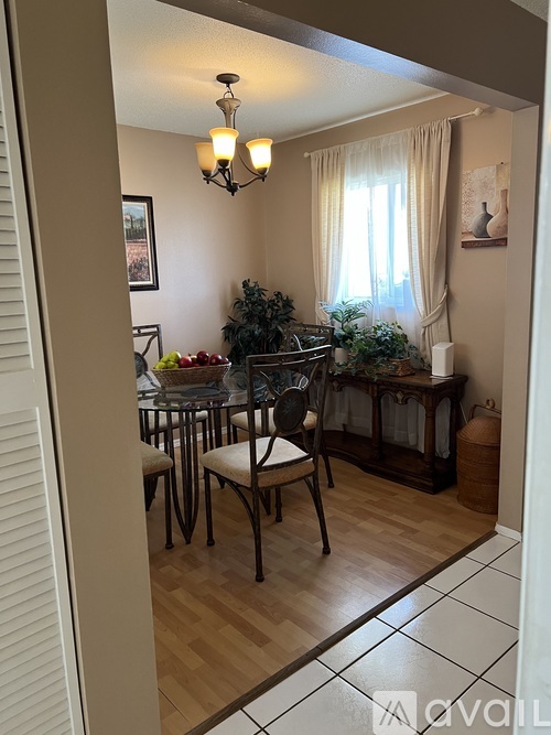 A dining room with a table set for four.