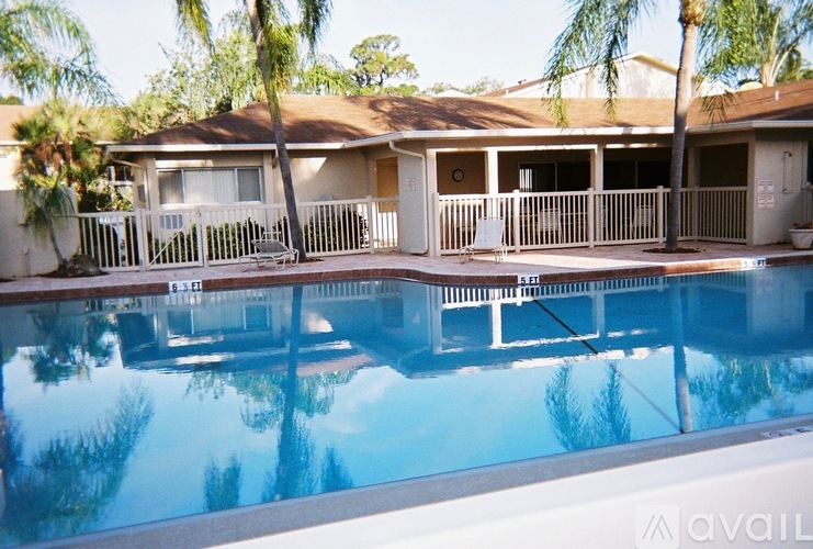 A house with a pool in front of it.