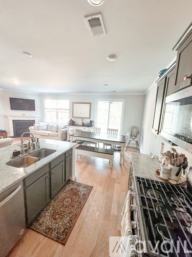 A modern kitchen with a stove top oven and a sink.