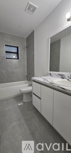 A bathroom with a toilet, sink, and shower.
