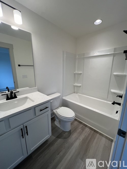 A bathroom with a toilet, sink, and bathtub.