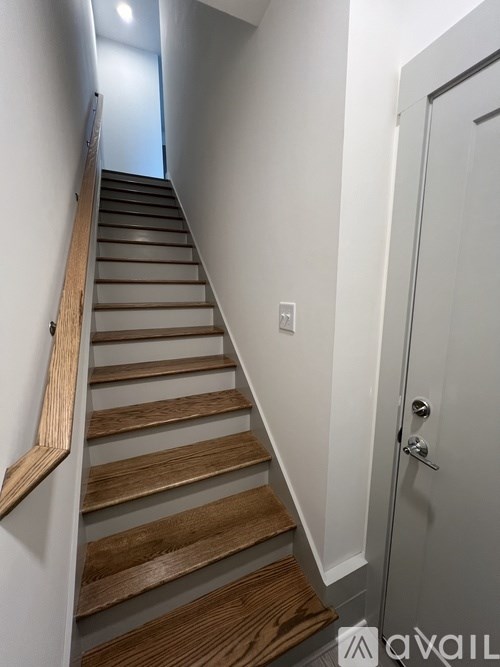 A staircase with wooden steps and a white door.