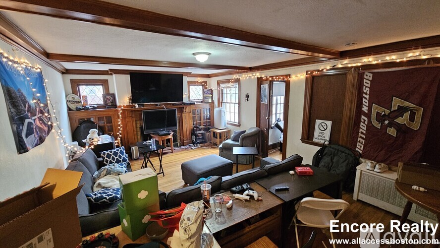 A living room with a Boston College banner on the wall.