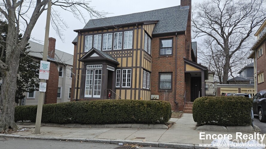 A house with a sign that says Encore Realty.