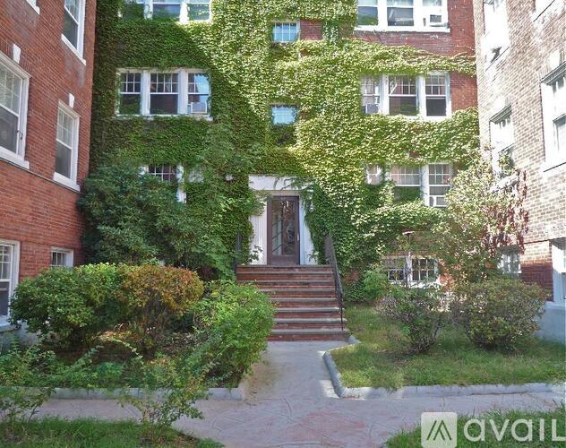 A building with a green plant on the side of it.