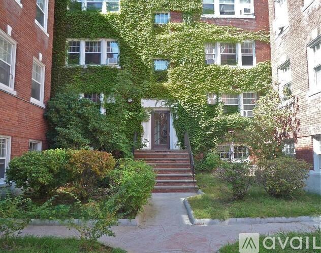 A building with a green plant on the side of it.