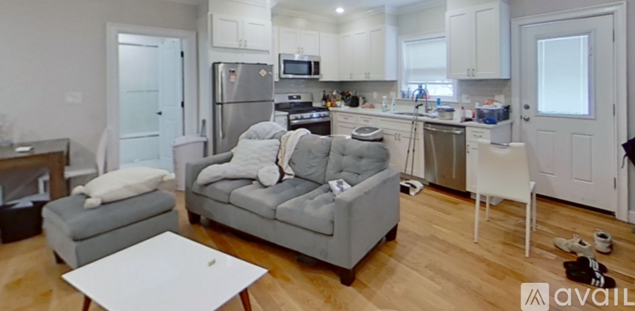A living room with a grey couch and a white coffee table.