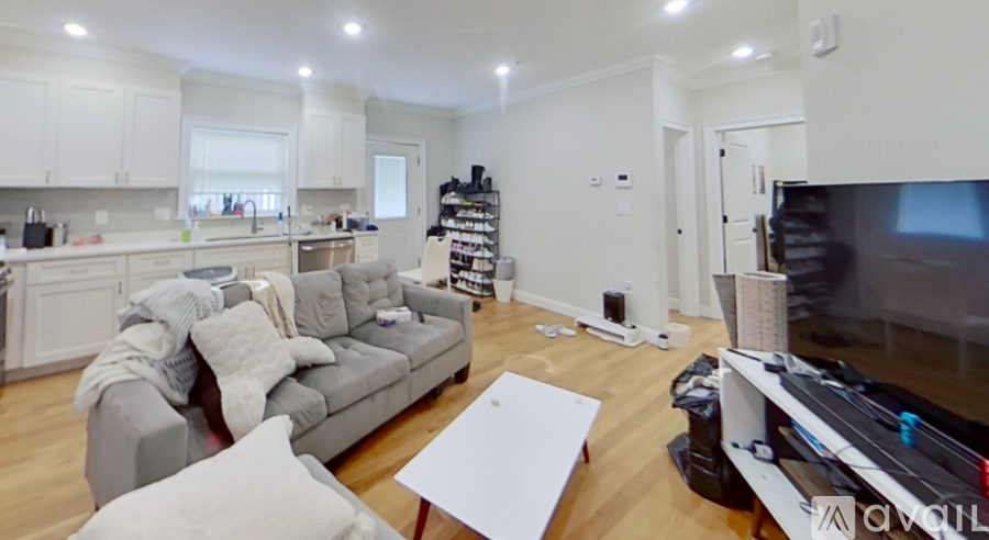 A living room with a grey couch and a white coffee table.