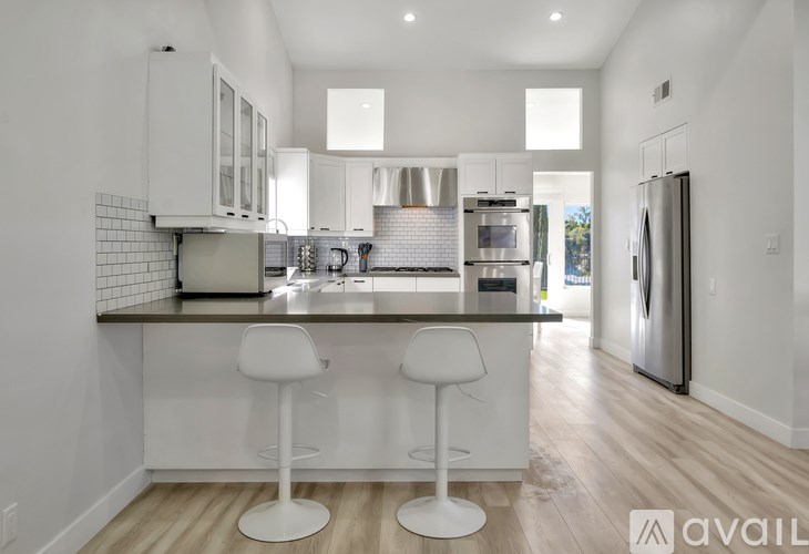 A modern kitchen with white cabinets and a center island.