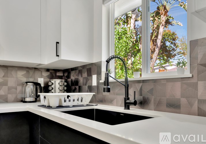 A modern kitchen with a black and white color scheme.