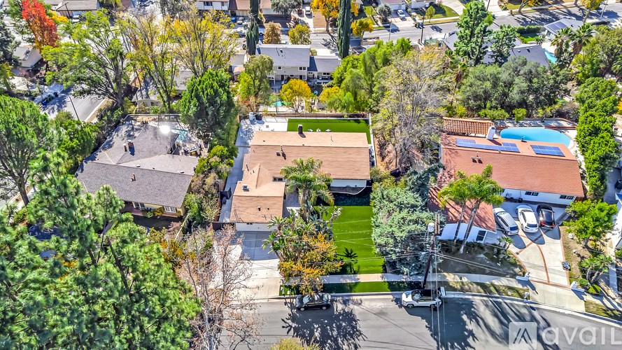 A bird's eye view of a neighborhood with houses and trees.