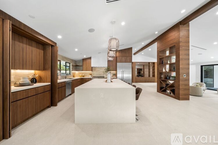 A modern kitchen with wooden cabinets and a white island.
