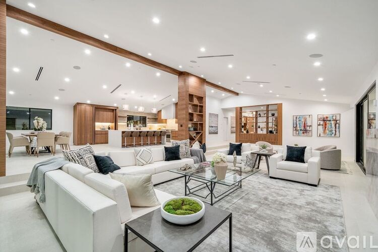 A modern living room with a bowl of fruit on the coffee table.