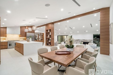 A modern dining room with a wooden table and chairs.