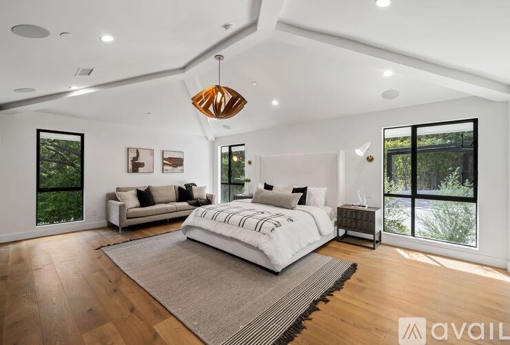 A bedroom with a large bed and a couch.