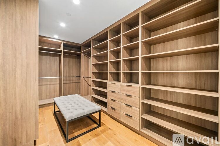A room with wooden shelves and a bench.