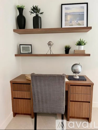A desk with a chair and a globe on it.