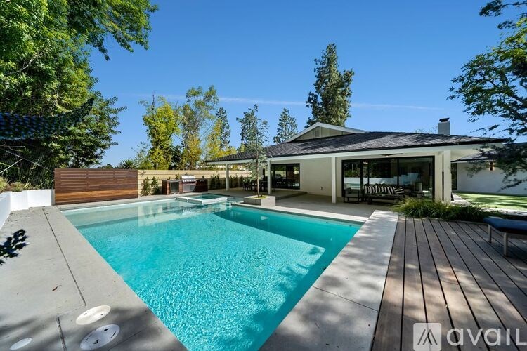 A modern house with a pool in the backyard.