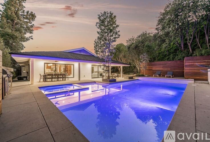 A modern house with a pool in the backyard.