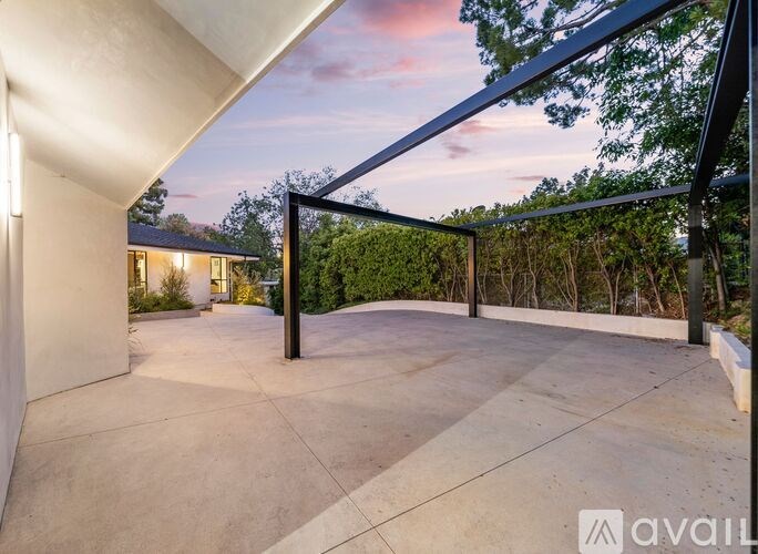 A modern house with a patio and a glass roof.