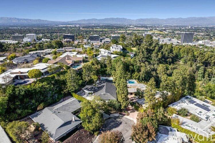 A bird's eye view of a residential area with houses and trees.