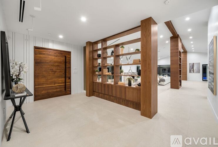 A modern interior space with a wooden bookshelf and a glass display cabinet.