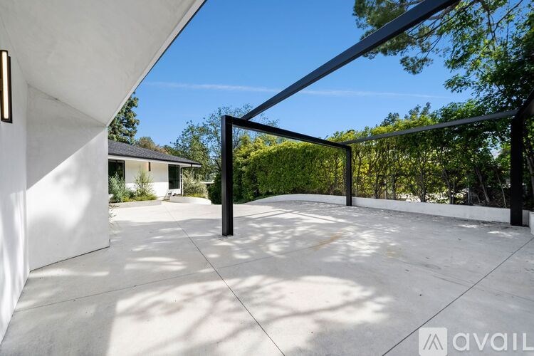 A modern house with a white exterior and a glass door.