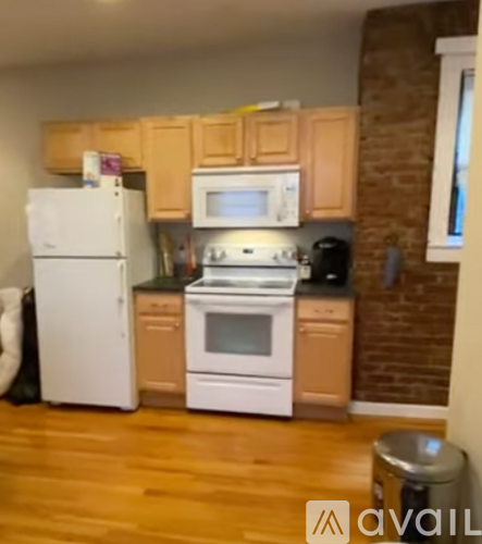 A kitchen with wooden cabinets and white appliances.