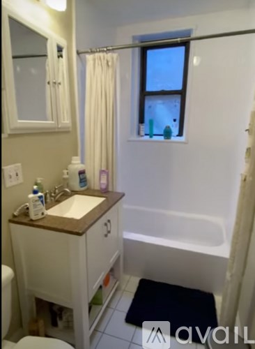 A bathroom with a sink, toilet and bathtub.