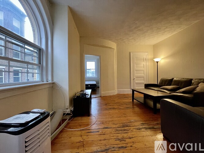A living room with a couch and a window.