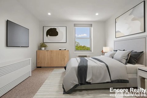 A modern bedroom with a large bed and a flat screen TV.