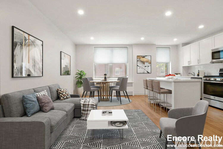 A living room with a grey couch and a coffee table in front of it.
