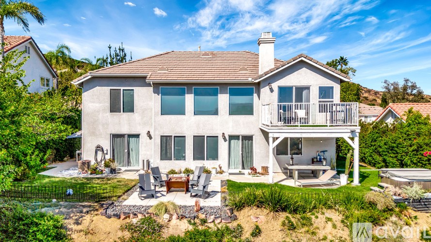 A large house with a patio and a pool.