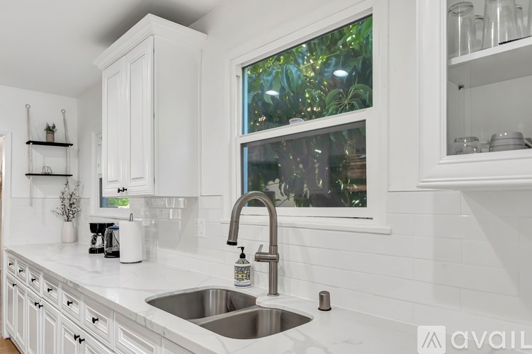 A kitchen with a window above the sink.