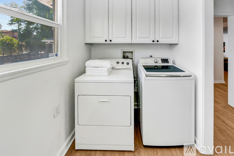 A white washing machine and dryer in a laundry room.