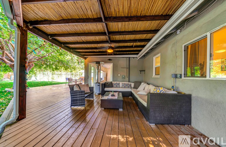 A wooden deck with a sofa and a table.