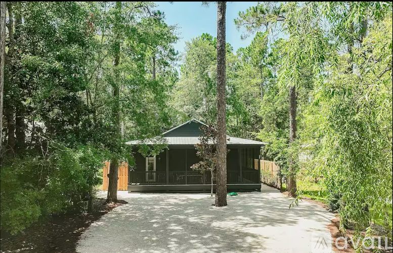 A house surrounded by trees in a forest.
