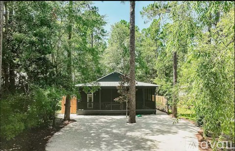 A house surrounded by trees in a forest.