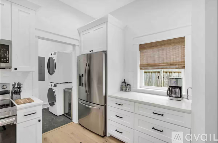 A kitchen with white cabinets and stainless steel appliances.