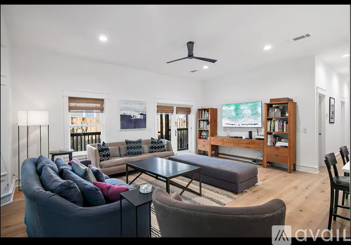 A living room with a grey couch and a black coffee table.